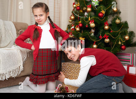 Kind in Santa hat Spaß und Spielen, Geschenke, Weihnachten Dekoration zu Hause, glücklich, Emotion, Winterurlaub Konzept Stockfoto