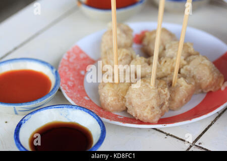 Chinesische gestreamte Knödel in der Platte mit Chili & Schwarz Essig Sauce. (Flache Tiefenschärfe von Objektiv) Stockfoto