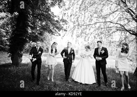 Hochzeit paar, Brautjungfern und groomsman Warten auf bester Mann, um eine Flasche Champagner in einer atemberaubenden Natur Ecke geöffnet. Stockfoto