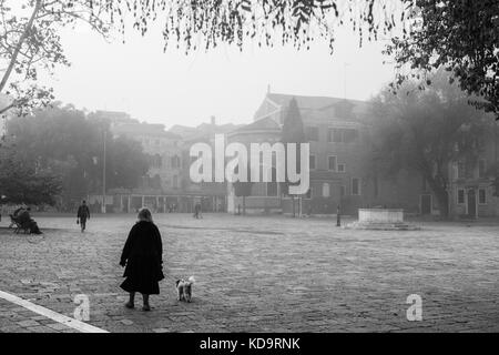 Venedig, Italien. 11. Oktober, 2017. (Bilder in Schwarz und Weiß übernommen wurde) eine Frau geht in San Polo Platz in einer nebligen Morgen in Venedig, Italien. In diesem Zeitraum in Venedig beginnt der erste neblige Morgen. © Simone padovani/Erwachen/alamy leben Nachrichten Stockfoto