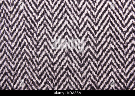 Die Textur der schwarzen und weißen Wollmantel. Stockfoto