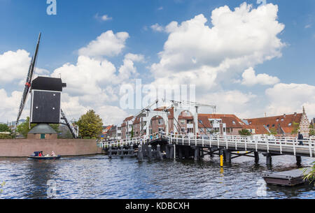 Weiße Brücke und historische Windmühle an einem Kanal in Leiden, Holland Stockfoto