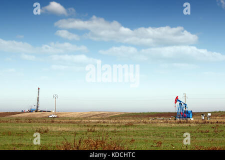 Ölpumpe Jack und Land Bohranlage auf dem Feld Stockfoto