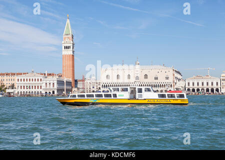 Gelbe Alilaguna Fähre vorbei am Campanile und Dogenpalast, San Marco, Venedig, Italien Stockfoto