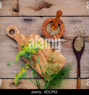 In der Nähe blühender Zweig von Fenchel und getrocknetem Fenchel Samen auf rustikalen Holzmöbeln Hintergrund mit Flach. Stockfoto