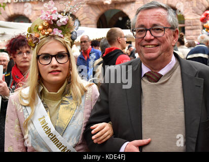 Weimar, Deutschland. Oktober 2017. Weimars Bürgermeister Stefan Wolf (SPD) und die Zwiebelmarktkönigin, die 19-jährige Gina-Marie Hildebrandt-Kanhold, schlendern auf dem 364. Weimarer Zwiebelmarkt in Weimar am 13. Oktober 2017 vorbei. Das berühmteste Volksfest Thüringens zieht bis zum 15. Oktober rund 300,000 Besucher an. Rund 500 Stände bieten die beliebten rot-weiß geflochtenen Zwiebelbündel, warme Zwiebeltorte, Thüringer Bratwurst, Getränke und Kunsthandwerk an. Quelle: Martin Schutt/dpa-Zentralbild/dpa/Alamy Live News Stockfoto