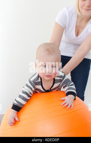 Verärgert Junge mit dem fitball auf weißem Hintergrund Stockfoto