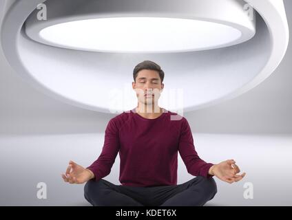Digital composite des Menschen meditieren in futuristischen Raum Stockfoto