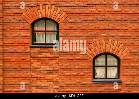 An der Wand eines alten roten Backsteinbau mit zwei Fenster Stockfoto