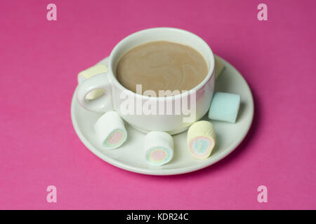 Heiße Schokolade mit Marshmallows in einem keramischen Cup auf rosa Papier Hintergrund Stockfoto