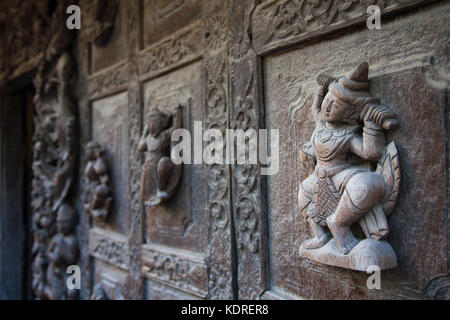 Ein Detail des Shwenandaw-Klosters aus dem 19. Jahrhundert, das eine Holzschnitzerei eines buddhistischen Mythos in der Stadt Mandalay in Myanmar zeigt Stockfoto