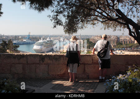 Urlaub Reisen und Tourismus. Touristen, die sich in der Aussicht von den oberen Barrakka Gardens, Valletta, Malta, mit einem Kreuzfahrtschiff in der Ferne sichtbar Stockfoto