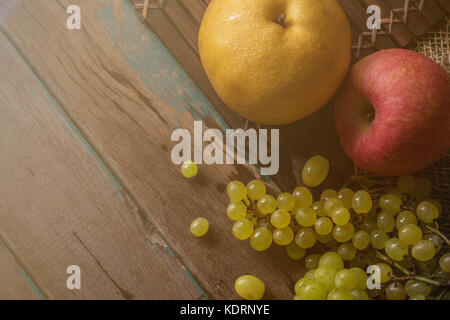 Apfel und Birne auf alten Holzboden. Stockfoto
