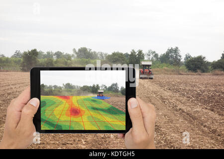 Smart Landwirtschaft Konzept, Landwirt mit Tablet lesen Sie Infrarot in Traktor mit High Definition Bodenkartierung während der Aussaat, tiefen Boden während eines Scans Stockfoto