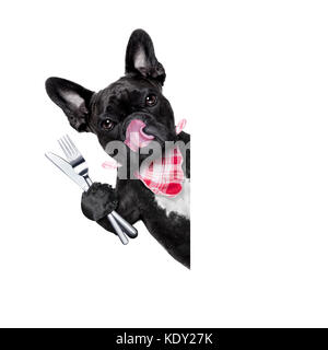Hungrig französische Bulldogge Hund mit Geschirr oder Besteck bereit, Dinner oder Lunch zu essen, hinter weißen leeren Banner oder Plakat, Zunge heraus, isolat Stockfoto