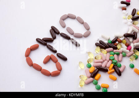 Konzeptionelle Hand schreiben Bildunterschrift inspiration Medical Care Health Concept mit Pillen Drogen geschrieben Kapsel Wort GVO-Saison auf Weiß isoliert backgr Stockfoto