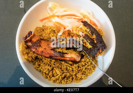 Gegrillter Lachs und ein Reispilaf in einer weißen Schüssel Stockfoto