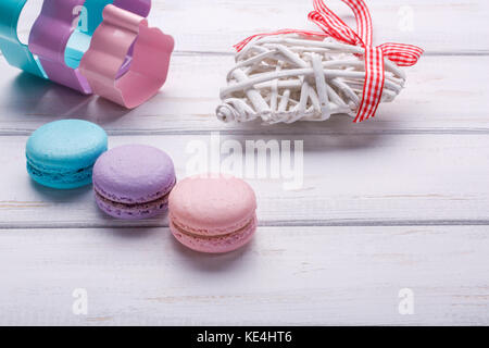 Süß und bunt französische Makronen oder Macarons wurde auf hölzernen weißen Hintergrund. Dessert für Valentinstag. Ort oder Platz für Text Stockfoto
