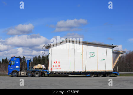 Mariehamn, Finnland - 23 April, 2016: Blaue Volvo fh Semi Truck ist ein Fertighaus Modul als übergroße Belastung im Süden Finnlands zu transportieren. Stockfoto