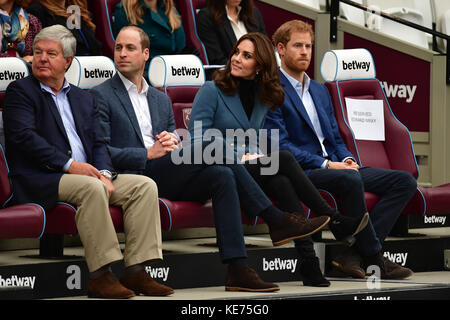 Sir Keith Mills (links), Vorsitzender der Royal Foundation, sitzt zusammen mit dem Herzog und der Herzogin von Cambridge und Prinz Harry im Londoner Stadion von West Ham United, während sie an der Abschlussfeier für mehr als 150 Trainerlehrlinge teilnehmen. Stockfoto