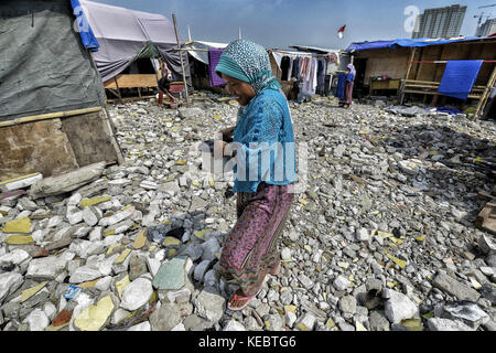 Jakarta, Java, Indonesien. 26 Aug, 2016. eine Frau gesehen, die Wasser in den Pasar ikan Nachbarschaft von Jakarta zu kochen. im April letzten Jahres Hunderte von Soldaten und Polizei pasar Ikan stürmten, einer historischen Fisherman Nachbarschaft nördlich von Jakarta, und alles in Schutt und Asche gelegt. Dort gibt es gemauerte Häuser, jetzt gibt es Berge von Schutt und Zelte. Die Bewohner nur ungern die Nachbarschaft und sich weigern, die Unterkünfte von offiziellen Schutz durch die Behörden zu bewegen zu lassen, weil sie behaupten, sie können es sich nicht leisten, sie sind Räumungen mit fast keine Ankündigung oder Cou Stockfoto