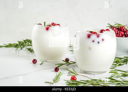 Ideen für Getränke für Weihnachten und Thanksgiving. White christmas margarita Punch mit Preiselbeeren und Rosmarin, auf einem weißen Marmor Tabelle, kopieren Raum Stockfoto