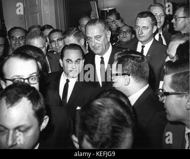 US-Präsident Lyndon B. Johnson und Gouverneur George Wallace (Demokrat von Alabama) werden gezeigt, wie sie nach ihrem dreistündigen Treffen am 13. März 1965 von Reportern in der Lobby des Weißen Hauses in Washington, DC gemobbt wurden. Der Präsident eskortierte den Gouverneur durch die Lobby zu wartenden Fernsehkameras, wo der Vorstandschef und Wallace kurze Aussagen machten. Kredit: Benjamin E. 'Gene' Forte / CNP /MediaPunch Stockfoto