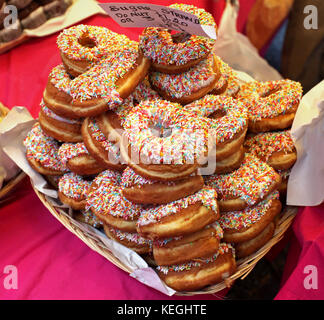 Frisch gebackene donuts Haufen mit bunten Dekoration sprengte auf der Oberseite Stockfoto