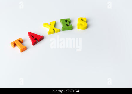 Das Wort Steuer auf weißem Hintergrund aus bunten Buchstaben. Stockfoto