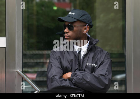 Porträt der jungen afrikanischen männlichen Sicherheit Schutz stehende Arme gekreuzt Stockfoto