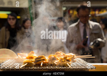 Gegrillten Meeresfrüchten Jakobsmuscheln und Meer ​​urchin Eier Spieß mit Rauch, japanisch Essen in Tsukiji Fischmarkt, Japan. Selektive konzentrieren. Stockfoto