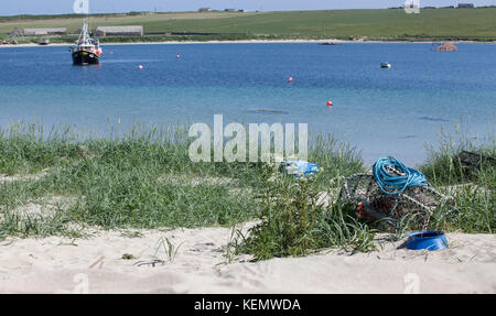 orkney Fischerboot und Hummertopf am Strand Stockfoto