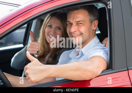 Nahaufnahme der glücklichen Paare innerhalb der neu erworbenen Auto sitzen Stockfoto
