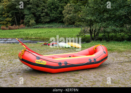 Schlauchboot und Kanus am Flussufer Stockfoto