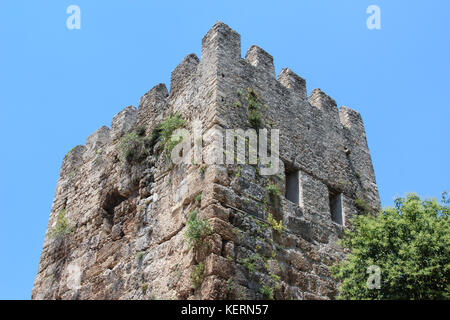 Der alte Turm auf der alten Hadrianstor in Antalya, Türkei. auf dem Hintergrund der blauen Himmel und grüne Bäume. Stockfoto