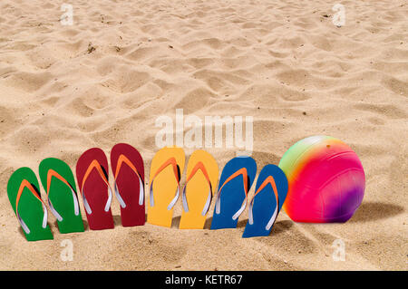 Mann Lebensstil vier Entspannen flip flops auf Orange Beach Sand und Volleyball Stockfoto