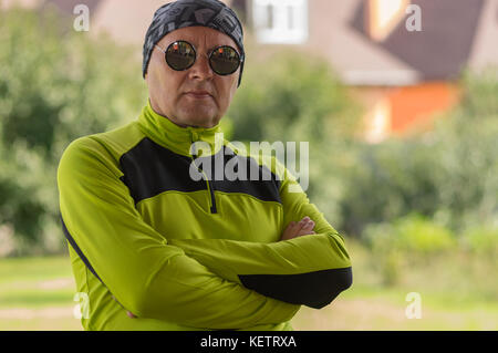 Outdoor Portrait von reifer Mann tragen Kopftuch buff Schal und Sonnenbrille Stockfoto