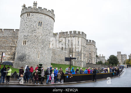 Windsor, Großbritannien. 23. Oktober, 2017. Touristen warten im Regen für den Wachwechsel Zeremonie im Schloss Windsor. Credit: Mark Kerrison/Alamy leben Nachrichten Stockfoto