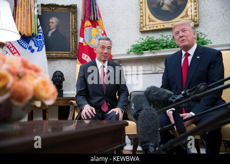 Washington, DC, USA. Oktober 2017. US-Präsident Donald Trump (R) begrüßt Premierminister Lee Hsien Loong (L) von Singapur im Oval Office vor einer Reihe von Treffen zwischen den beiden im Weißen Haus in Washington, DC, USA, am 23. Oktober 2017. Das Treffen findet weniger als zwei Wochen vor einer ausgedehnten Reise von Präsident Trump in den asiatisch-pazifischen Raum statt. Kredit: Shawn Thew/Pool über CNP - KEIN KABELSERVICE - Kredit: Shawn Thew/Consolidated News Fotos/Shawn thew - Pool über CNP/dpa/Alamy Live News Stockfoto