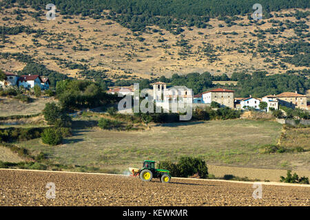 Landwirtschaftliche Szene Landwirt Spritzen mit Traktor durch Dorf Ollo in Sierra de Geschichte in Biskaia Baskenland im Norden Spaniens Stockfoto