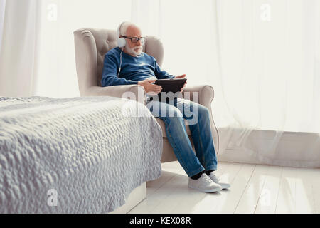 Entspannt Mann im Sessel sitzt Stockfoto