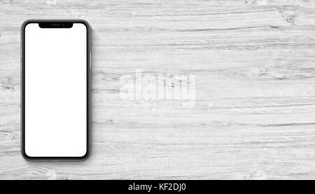 Smartphones wie iPhone X mockup flach Draufsicht liegen auf Holz- büro Schreibtisch. Banner mit kopieren. Stockfoto