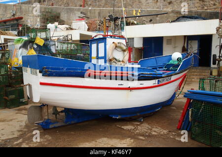 Die Cascais Marina in Portugal ist ein funktionstüchtiger Fischereihafen mit bunten Fischerbooten, die für die nächste Reise bereit sind Stockfoto