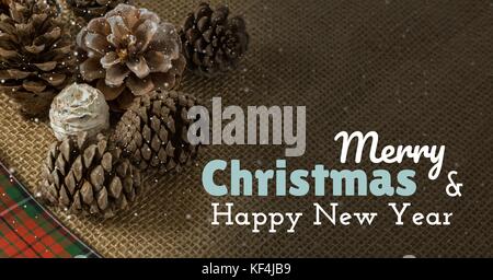 Digital composite Der frohe Weihnachten und ein glückliches neues Jahr text auf Weihnachten Hintergrund mit Schnee Stockfoto