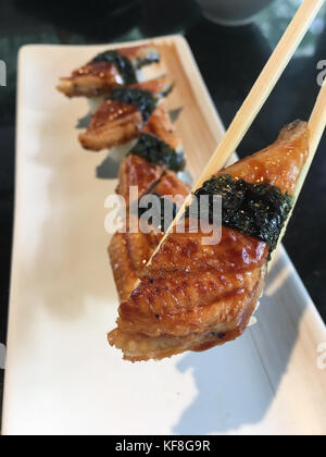 Unagi geräucherter Aal Sushi auf Essstäbchen, Japanisch Essen Stockfoto