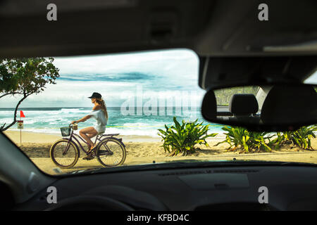 Usa, Hawaii, Oahu, Northshore, eine junge Frau, reiten ihr Fahrrad auf dem Weg entlang der Sunset Beach Stockfoto