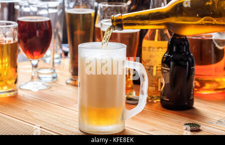 Bier zapfen in einem frosty Becher Bier in einem Pub Hintergrund Stockfoto