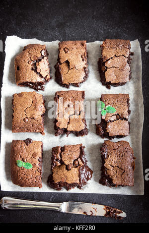 Brownies. Hausgemachte Schokolade Fudge brownies auf rustikalen schwarzer Hintergrund, Ansicht von oben. Stockfoto