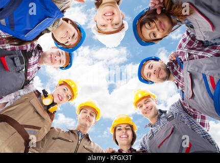 Direkt unter Portrait von Multiethnischen Architekten in Unordnung gegen Sky Stockfoto