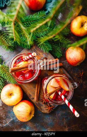 Zwei Gläser mit einem heißen Weihnachten Getränk aus Cranberries und Äpfeln mit Gewürzen, Glühwein, Punsch oder Grog. Stockfoto